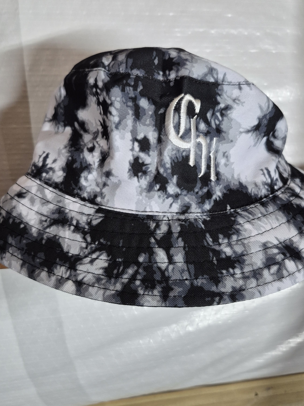 Black & White Tie-Dye Bucket Hat with Embroidered 'CHI' Logo